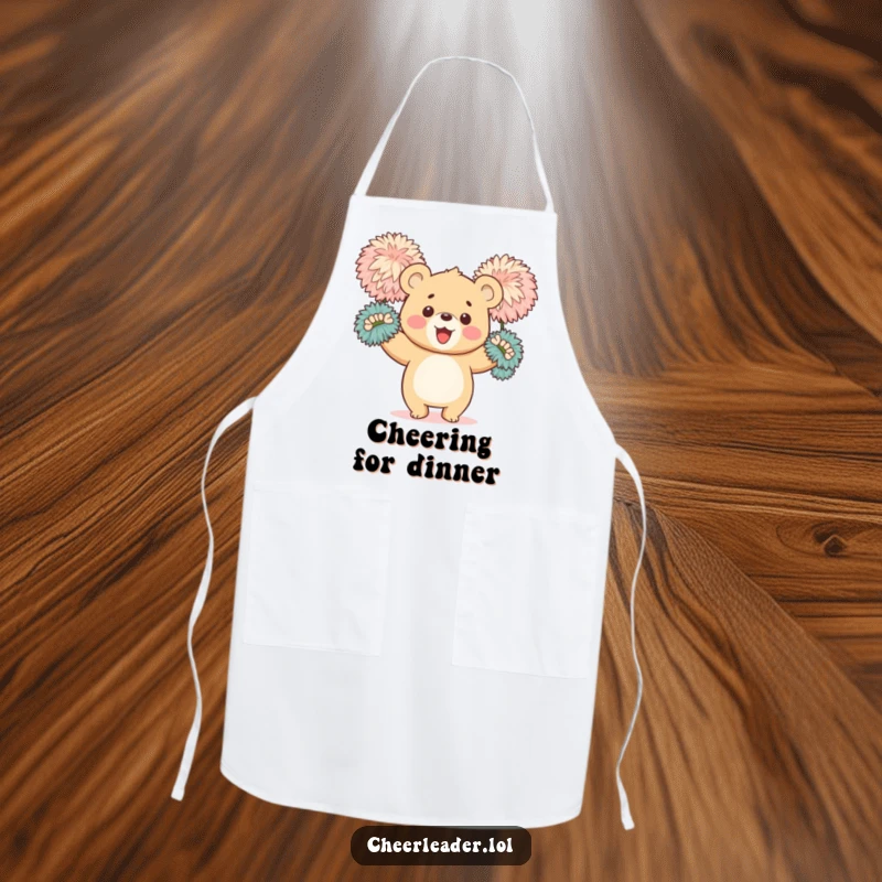 Funny apron showing a happy bear cub enthusiastically waving large, fluffy pom-poms, ideal for keeping messes at bay with cheer.