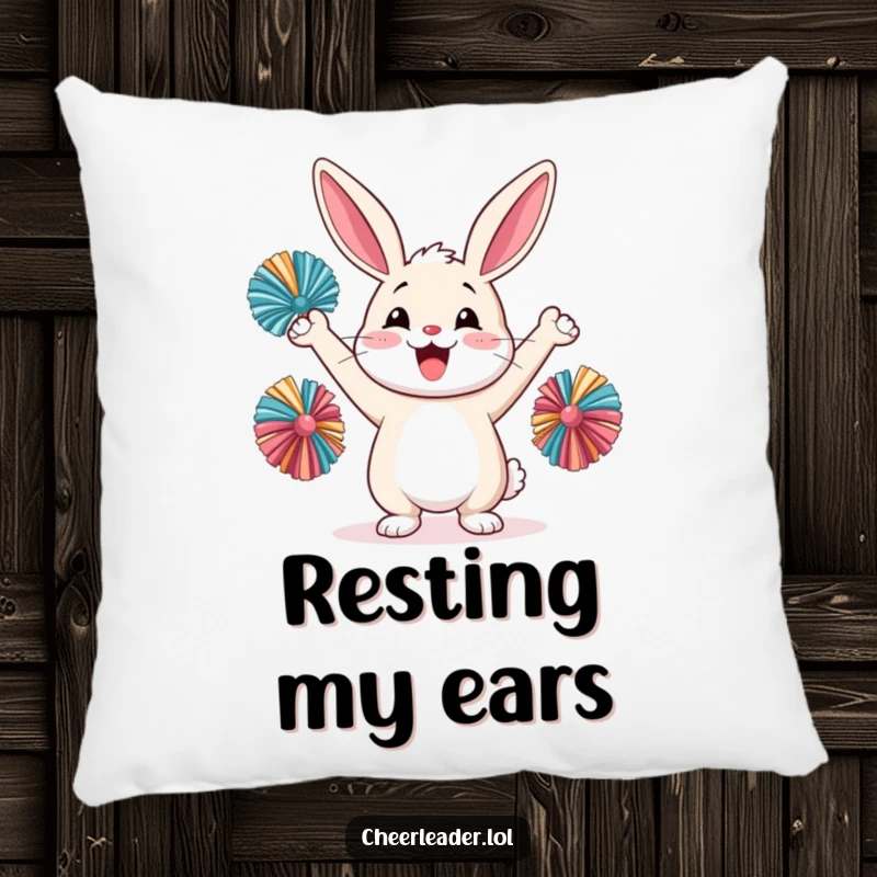 Funny happy rabbit cheering with pom-poms, on a soft pillow, cute animal graphic.