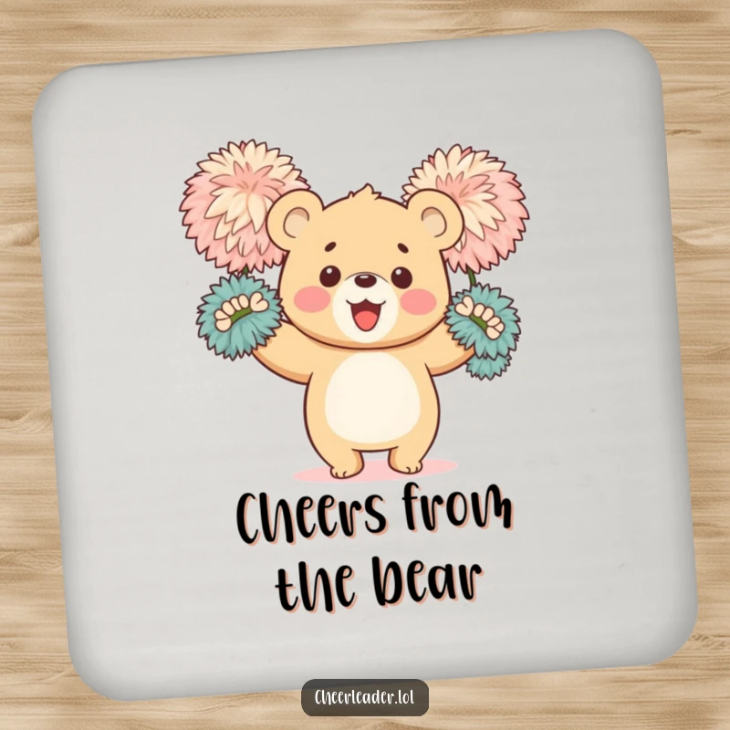 Funny drink coaster featuring a happy bear cub enthusiastically waving large, fluffy pom-poms, adding a touch of cheer to any surface.