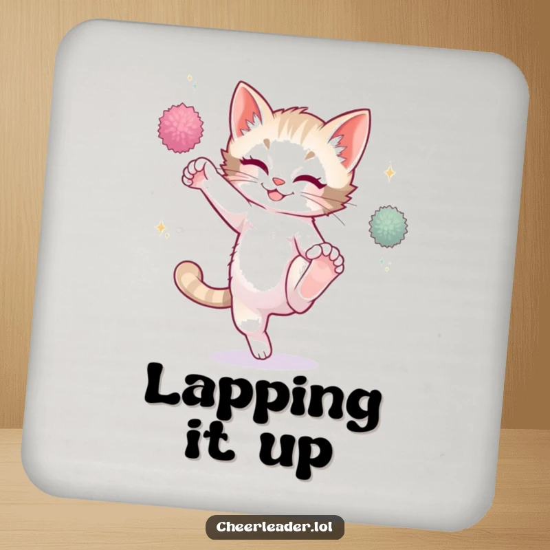Funny playful kitten high kicking with sparkling pom-poms, on a drink coaster, cute cat graphic.