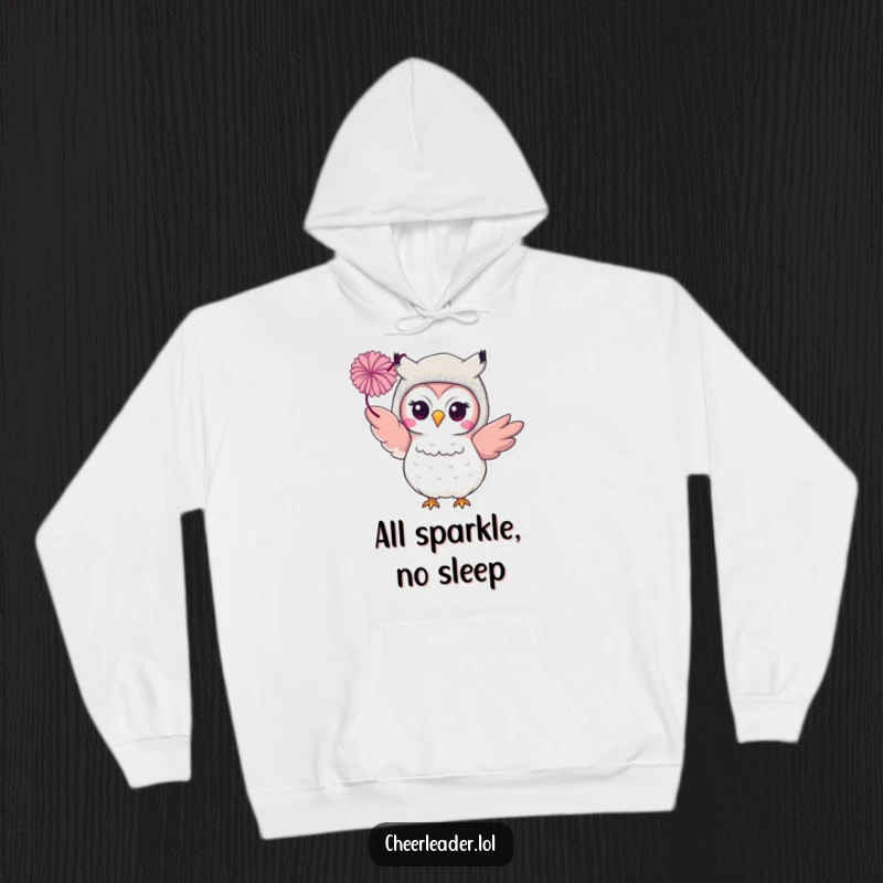Funny smiling owl in a glittery costume, ready to throw a pom-pom, featured on a warm hoodie. Glamorous comfort.