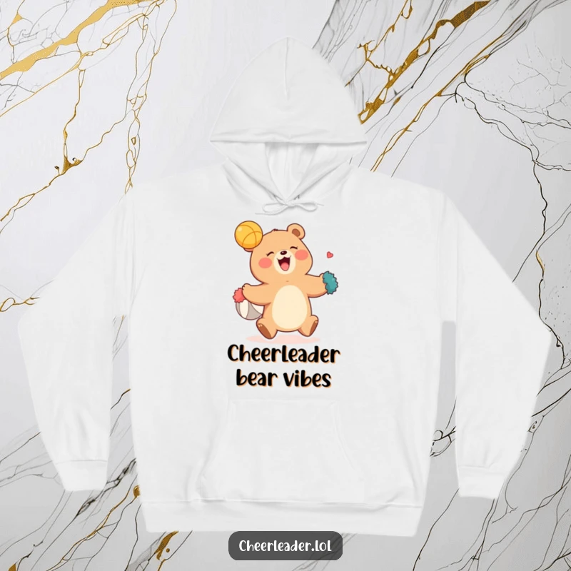 Funny hoodie with an adorable, giggling bear enthusiastically catching a ball using its bright pom-poms, radiating fun and sportiness.