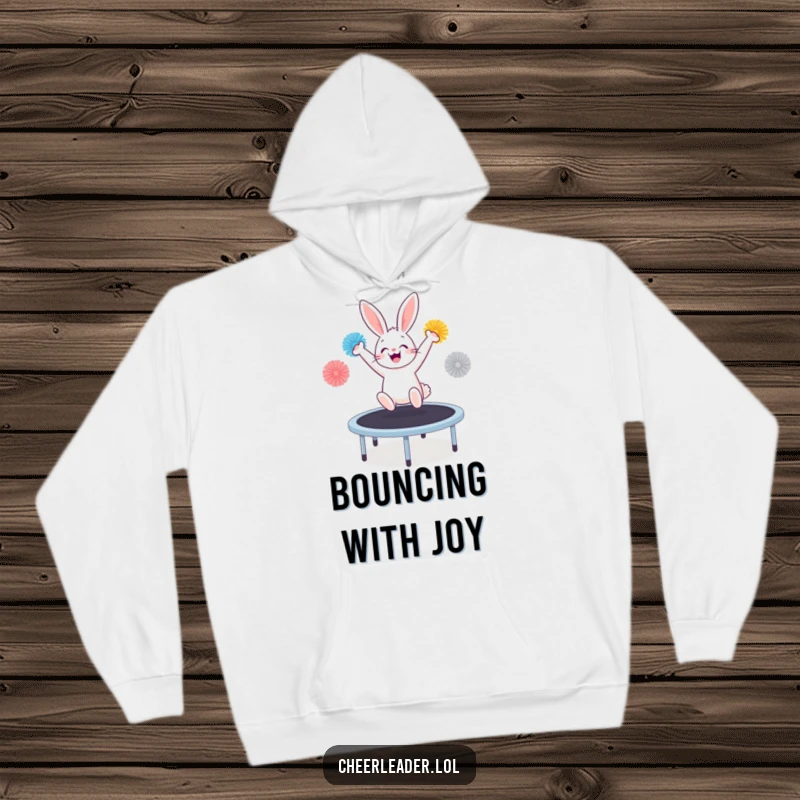 Funny bunny enthusiastically bouncing on a trampoline with pom-poms, depicted on a cozy hoodie.