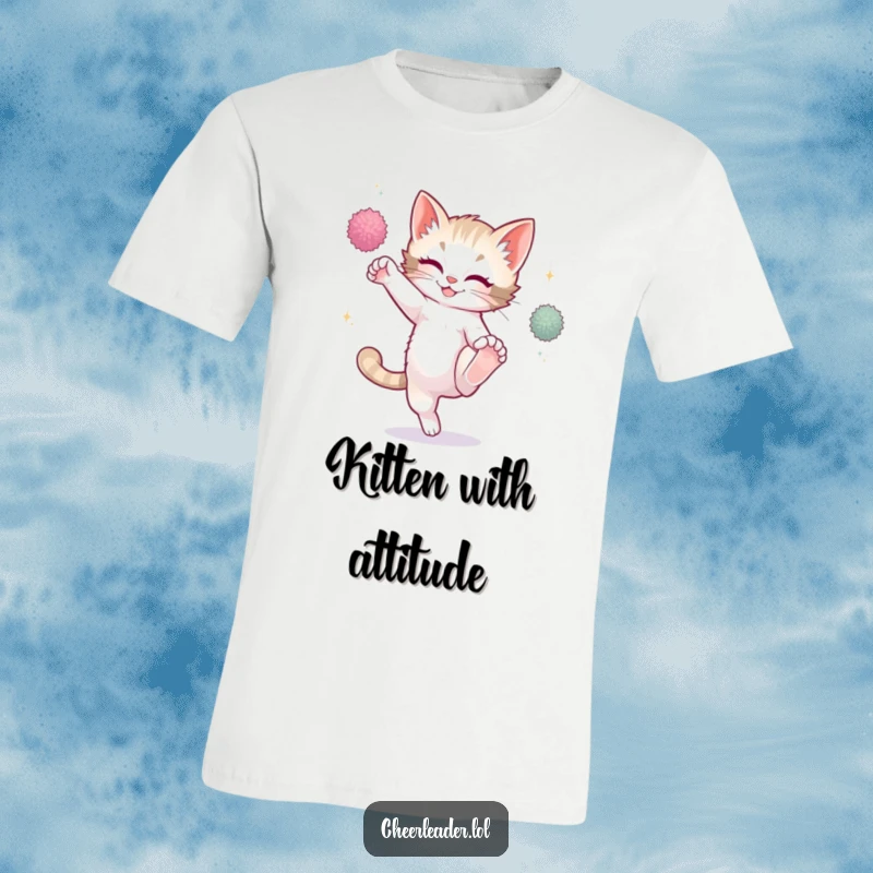 Funny playful kitten mid-high kick with sparkling pom-poms, wearing a fun t-shirt, cute cat graphic.