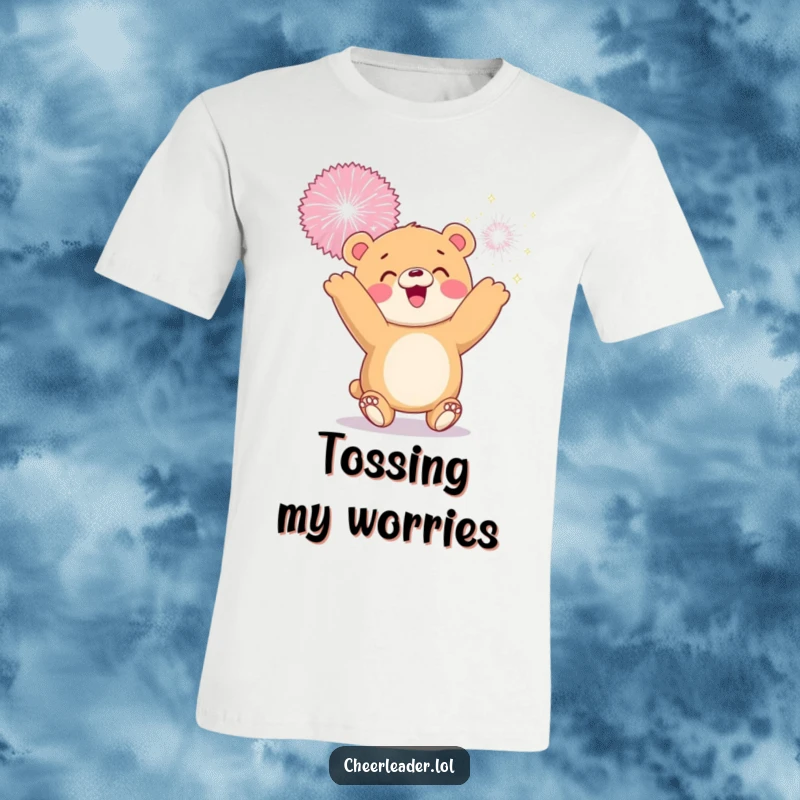 Funny t-shirt of a smiling bear cub playing with a giant sparkly pom-pom, radiating pure playful joy.