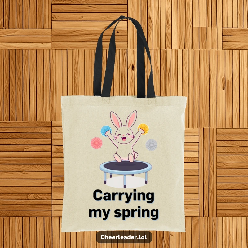 Funny bunny on a trampoline with pom-poms, cheering wildly, printed on a durable and stylish tote bag.