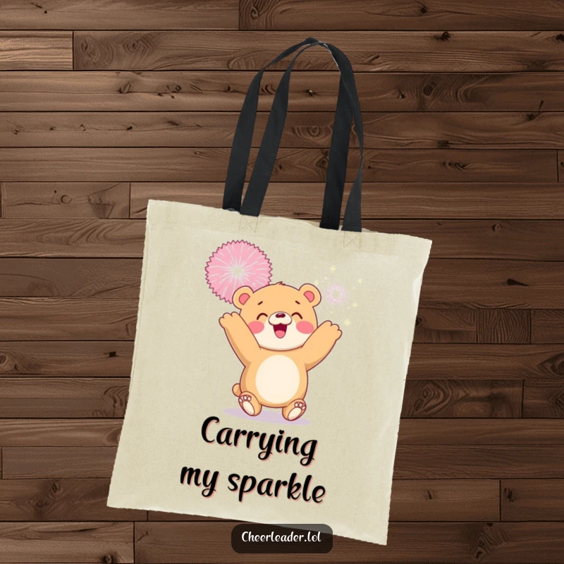 Funny tote bag with a smiling bear cub tossing a giant sparkly pom-pom, symbolizing joy and playful moments.