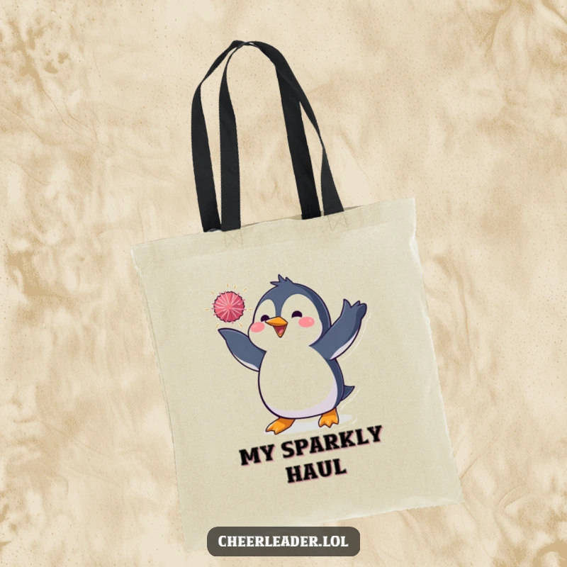 Funny tote bag showcasing a penguin in a dynamic pose, tossing a sparkly pom-pom, perfect for carrying essentials with a touch of theatrical fun.