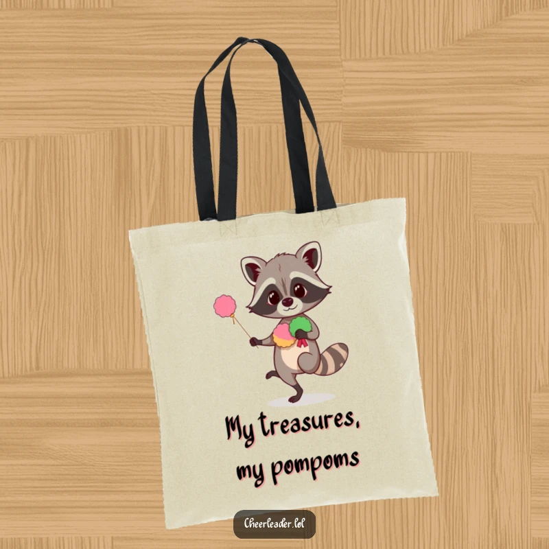 Funny raccoon tote bag featuring a curious animal balancing with pom-poms, a humorous and practical accessory for carrying items.